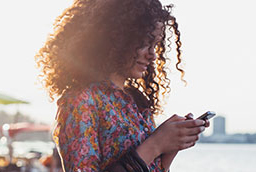Woman sending message on cell phone